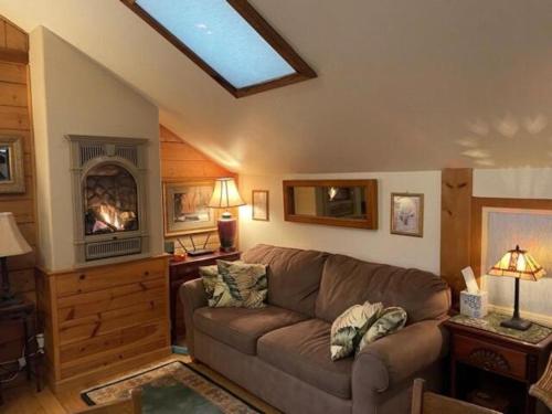 a living room with a couch and a fireplace at Vacation Rental with Spa and Pool on Winery near Healdsburg, California in Ingram