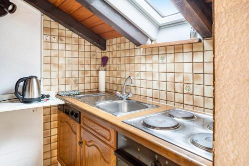 a kitchen with a sink and a stove at Ferienwohnung Hufenus in Breisach am Rhein