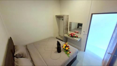 a room with a bed with flowers on it at Chamim Apartments Koh Lanta ชามิม in Phra Ae beach