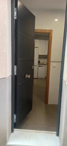 a door in a room with a hallway with a kitchen at Casa Carmen in Serón