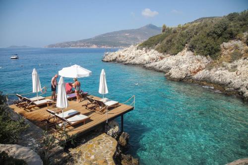 a group of people sitting on a dock in the water at Soothe Hotel in Kalkan