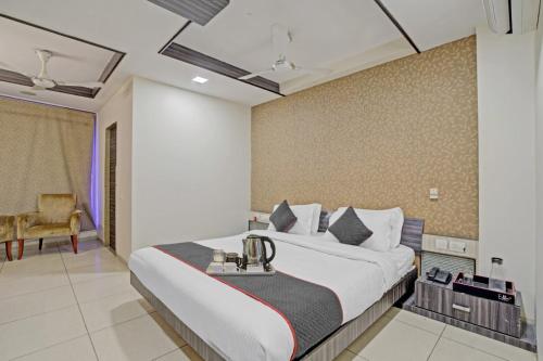a bedroom with a large bed and a chair at Hotel Marina FREE Airport Drop in New Delhi