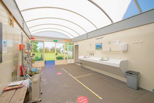a large bathroom with a large sink and a large window at Guesthouse Eindeloos in 't Zand - North Holland in 't Zand