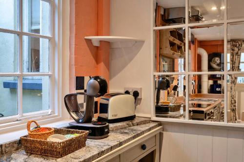 a kitchen with a counter with a coffee maker on it at Finest Retreats - Church House Annexe in Highbray