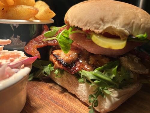 a sandwich with bacon and lettuce on a table at Bridge House Hotel in Bridport