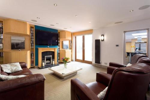 a living room with two couches and a fireplace at Spacious 4 Bedroom Apartment in Oxford City Centre, Near Colleges & Botanical Gardens in Oxford