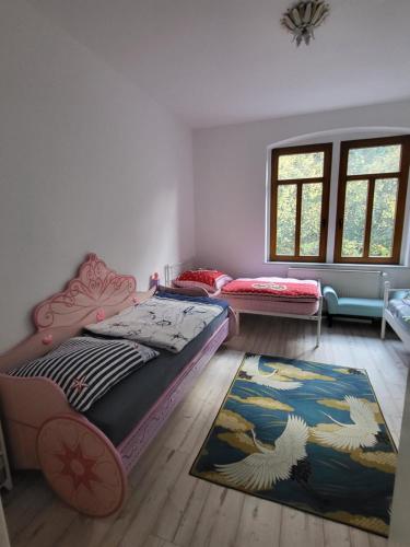 a room with two beds and a rug at Lilienstein in Königstein an der Elbe