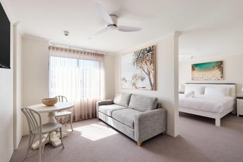 a living room with a couch and a bed at King Bed with Sofa Bed Studio at Manly - 3min walk to Corso & Manly Beach in Sydney