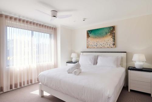 a white bedroom with a large white bed with a window at King Bed with Sofa Bed Studio at Manly - 3min walk to Corso & Manly Beach in Sydney