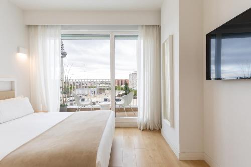 En eller flere senge i et værelse på Uma Suites O'Donnell