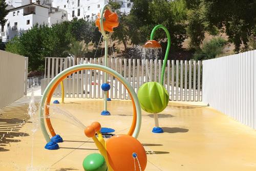 a playground with a bunch of different types of toys at La Casa Colores in Casares