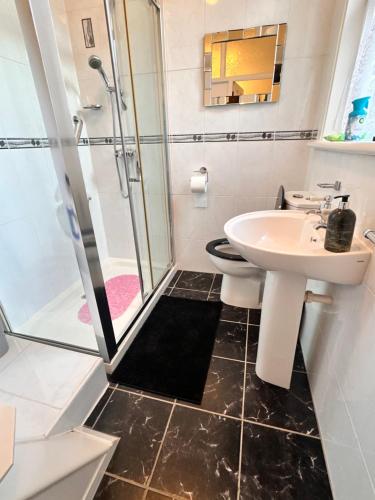 a bathroom with a sink and a shower at Private Rooms in Portsmouth in Portsmouth