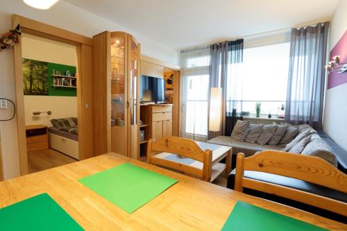 a living room with a table and a couch at Relax 6 in Hahnenklee-Bockswiese