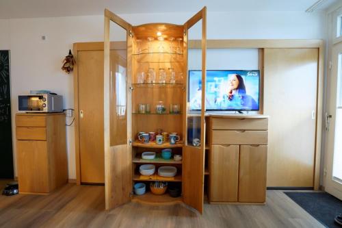 a room with a cabinet with a tv in it at Relax 6 in Hahnenklee-Bockswiese