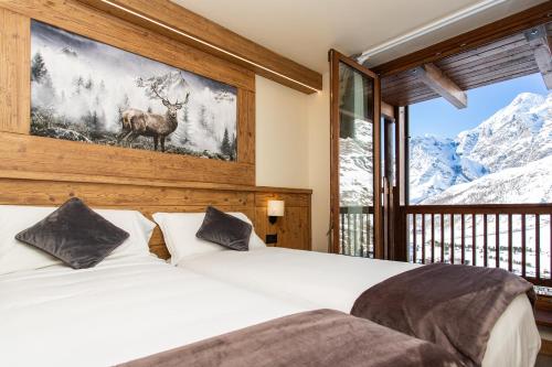 a bedroom with a bed with a deer on the wall at Hotel Meublé Furggen in Breuil-Cervinia