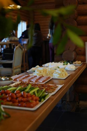 a table with many plates of food on it at Wood Hills Hotel & Resort in Mayrūbā