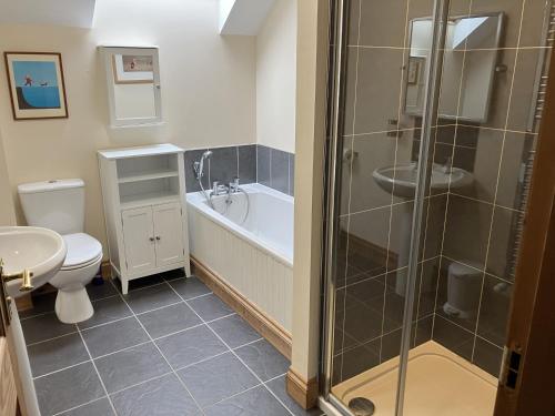 a bathroom with a shower and a toilet and a sink at Oiseval in Fort Augustus