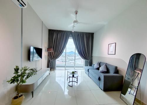 a living room with a blue couch and a window at Ipoh D Festivo Suites 6-10pax 10mins to Sunway Tambun by IWH in Ipoh