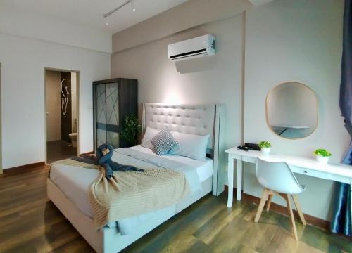a bedroom with a bed with a teddy bear sitting on it at Ipoh D Festivo Suites 6-10pax 10mins to Sunway Tambun by IWH in Ipoh