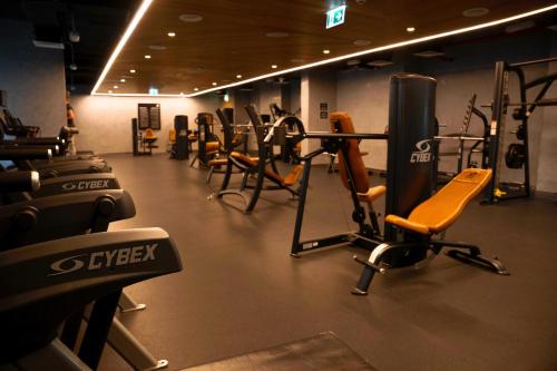 a gym with rows of exercise equipment in a room at Luxury Jr. 1BR in Mayan Yas Island in Abu Dhabi