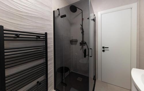 a shower with a glass door in a bathroom at Villa Palazzo Maestral beachfront by Villas Guide in Viniština