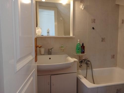a bathroom with a sink and a bath tub at pavliani house in Pavliani