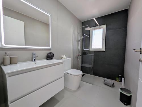 a white bathroom with a sink and a toilet at R-70 Oasis in Ciudad Quesada