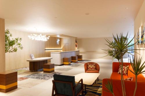 a living room with a table and chairs at Holiday Inn & Suites Sapporo Odori Park by IHG in Sapporo