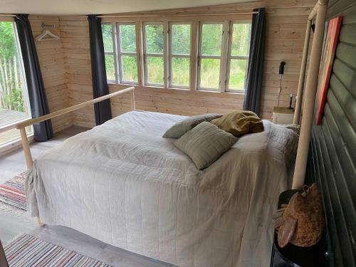 a bedroom with a bed in a room with windows at Wonderful Family Vacation Home in Ågerup