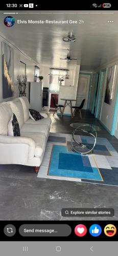 a living room with a white couch and a table at Vacazure in Saint Joseph