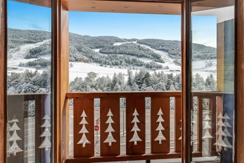 a window with a view of a snowy mountain at Family-Friendly Andorra Accommodation - Happy Rentals in El Tarter