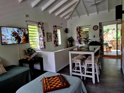 a living room with a chess board on a table at Cozy House with Terrace in Upper Prince's Quarter in Upper Prince's Quarter