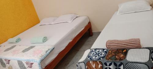 a pair of beds in a room withskirts at Ashwini home stay hampi in Hampi