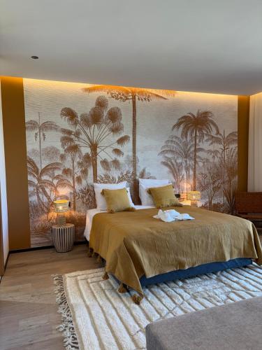 a bedroom with a large bed with a mural of palm trees at Villa Marleanis 5 suites 300m2 piscine chauffée privative 11m de long résidence avec gardien in Marrakesh