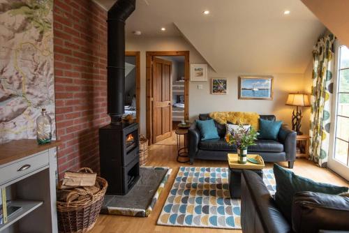 a living room with a wood stove at Tanar View in Aboyne