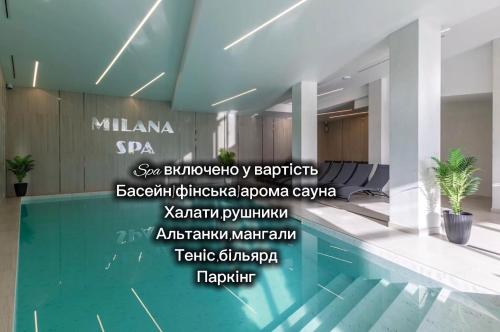 a swimming pool in a building with words on the wall at Milana SPA & Hotel - SPA included in Bukovel