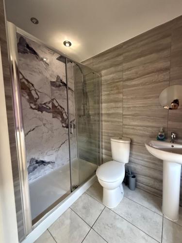 a bathroom with a toilet and a shower and a sink at chesterton Grove in Manchester