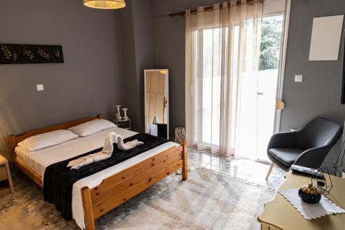 a bedroom with a bed and a desk and a chair at Comfort Zone - Spacious Apartment in Xanthi in Xanthi