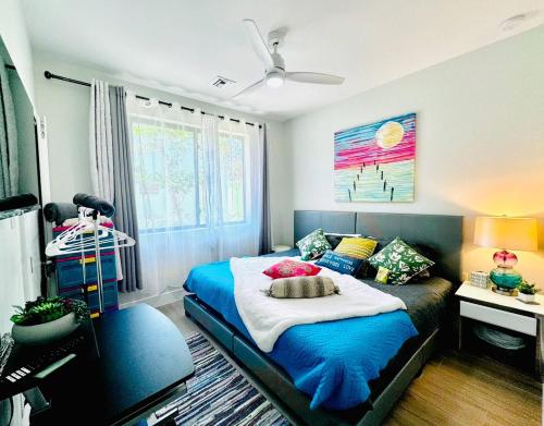 a bedroom with a bed and a desk and a window at Oceanfront Residency luxury 2B2B ,1-6 person ,terrasse, beach access garden pool in Old Man Bay