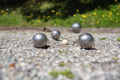 a group of silver balls sitting on the ground at Hotel La Prairie in Crans-Montana