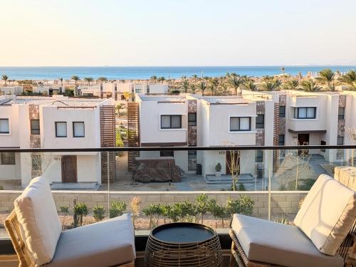 a balcony with a view of the beach and buildings at Panoramic Seaview Somabay 1BR Apartment in Mesca in Hurghada
