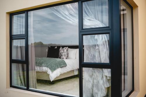 a room with a window with a bed in it at Santareme Breeze in Sea Vista