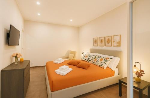 a bedroom with an orange bed and a dresser at Marine Case Vacanze in Palermo