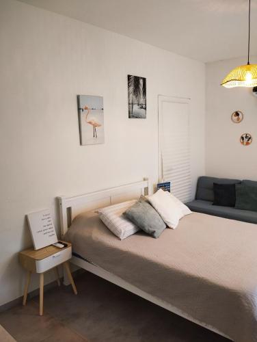 a bedroom with a bed with a laptop on it at Dekel Dom Baharava in Beʼer Ora