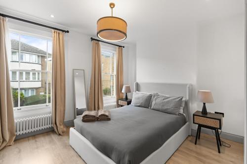 a bedroom with a bed and a large window at The North Kensington House in London