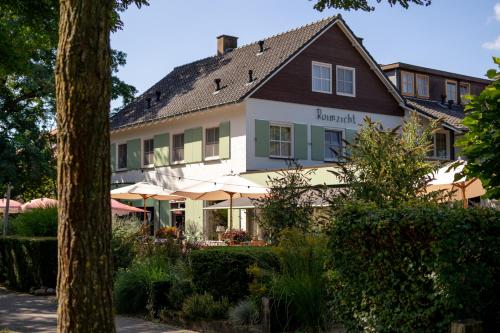 a large white building with a sign on it at Hotel Restaurant Ruimzicht in Zeddam