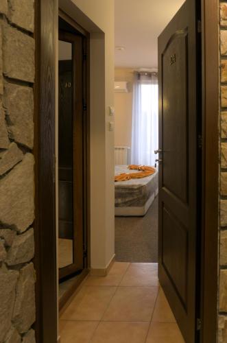 a hallway with a door leading to a bedroom at Todorovi Guest House in Stara Zagora