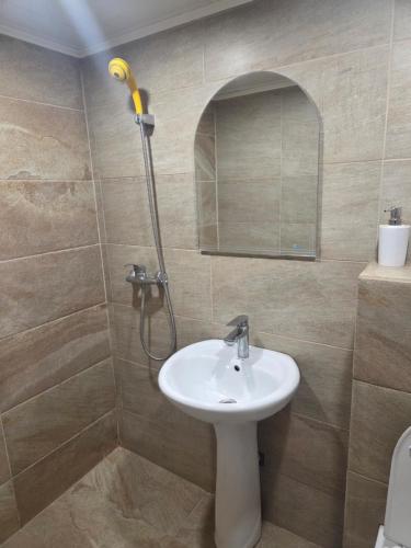 a bathroom with a sink and a shower at Hotel Zara Rooms in Stara Zagora