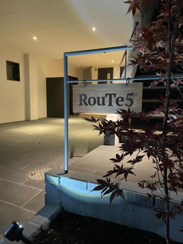 a sign for a building with a route sign at RouTe5 in Matsumoto