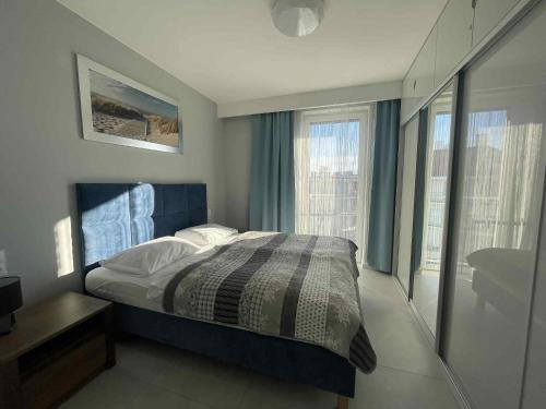 Кровать или кровати в номере Apartament Holiday 32